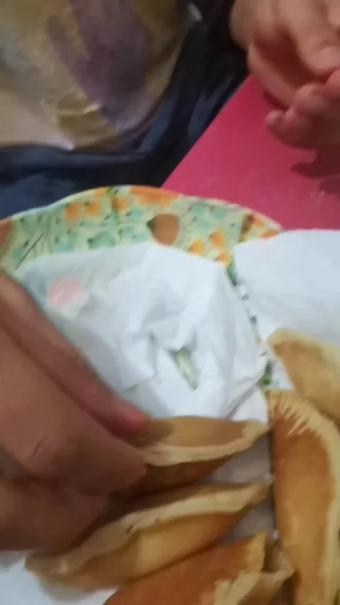 Hands preparing traditional Atayef Arabic pancakes, stuffing them with nuts and Stock Footage 333525252
