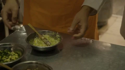 Hands Preparing Vegetable Filling in Metal Bowls on Kitchen Counter, Beijing Stock Footage 345879782
