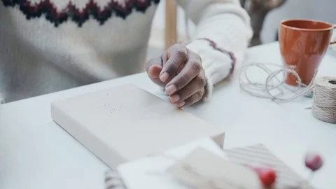 Hands preparing wrapping present with Candy Canes , rosemary pine for Christmas Stock Footage 100001399