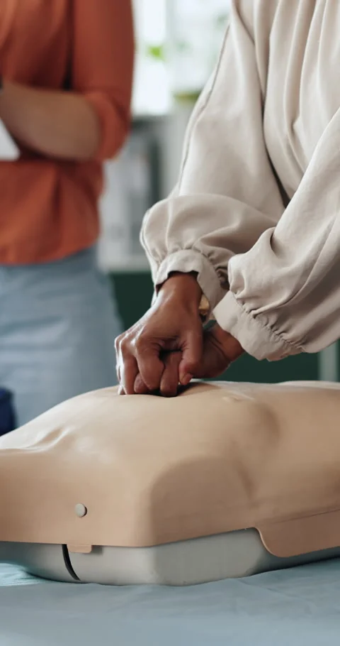 Hands, presentation and rescue with mannequin for cpr, teaching and gear at Stock Footage 332968024
