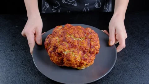 Hands Presenting Baked Bread on Dark Plate in Cooking Scene Stock Footage 341433403