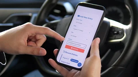 Hands press add to log a recent service entry in a car maintenance tracker app 스톡 동영상 315672047
