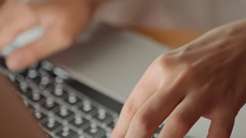 Hands press keys rapidly. Hotel room scene with active typing and illuminated Stock Footage 330534879