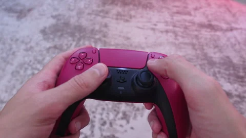Hands Pressing Buttons on Game Controller During Gameplay Stock Footage 327784711
