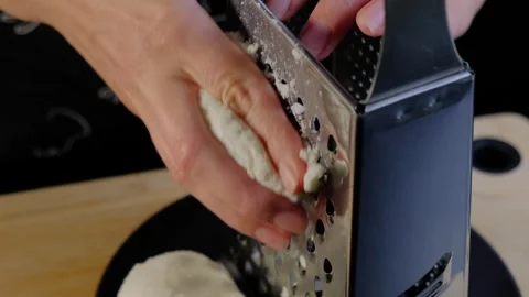 Hands Pressing Dough Through Food Mill in Cooking Stock Footage 341448976