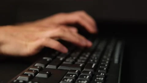 Hands pressing keyboard keys in dark room, everyday digital routine Stock Footage 318067246