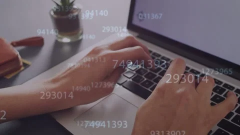 Hands pressing laptop keys and typing, starting numeric overlays flowing over Stock Footage 334744258