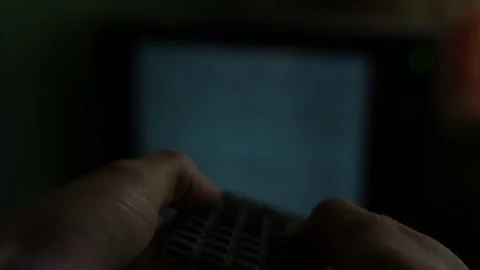 Hands pressing on a non-working remote control with dead batteries close-up Stock Footage 231942773