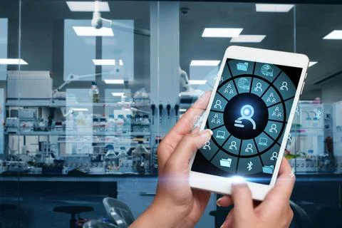Hands Pressing Screen Of Mobile Phone In Laboratory Showing The Futuristic .. Stock Photos
