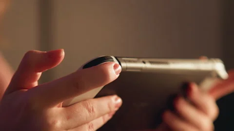 Hands pressing small control nub on smartphone edge with precise thumb input Stock Footage 343543634