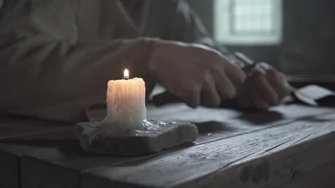 Hands of a prisoner cutting a quill pen inside a cell, camera tracking Vídeo Stock 341009862