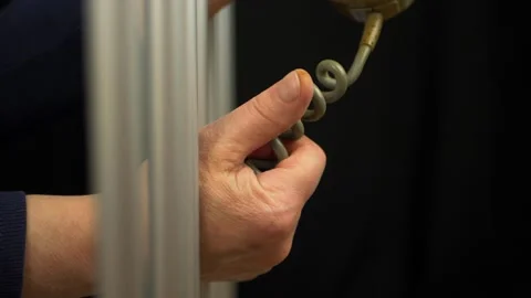 Hands of prisoner using a phone Stock Footage 153215734