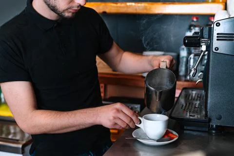 Hands of a professional barista working in a coffe cup. Preparing a coffee for a Stock Photos