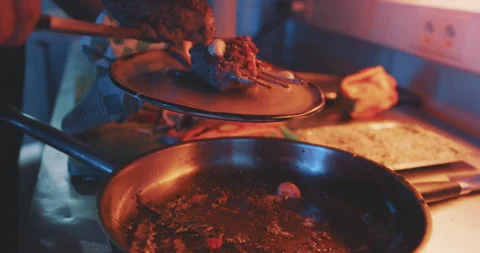 Hands of professional chef plating finished meal Stock Footage 203558262