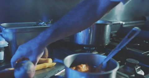 Hands of professional chef putting vegetables into boiling water Stock Footage 203558697
