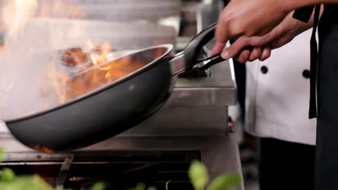 Hands of professional chef show cooking Asian food on frying pan with oil, .. Stock Footage 245129666