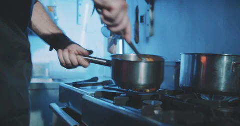 Hands of professional chef stirring meal Stock Footage 203559285