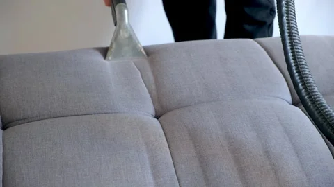 Hands of professional cleaner removing dirt from sofa using vacuum cleaner. Video stock 311799843