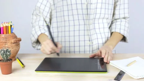 Hands on a professional graphics tablet. Record calculations in a notebook Stock-Footage 104388094