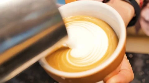 Hands of professional making latte art in specialty coffee shop. 動画素材 334648314