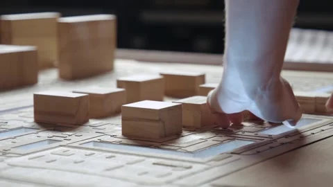Hands of Professional Man Constructing Architecture Model of Urban City Building Stock Footage 283526641