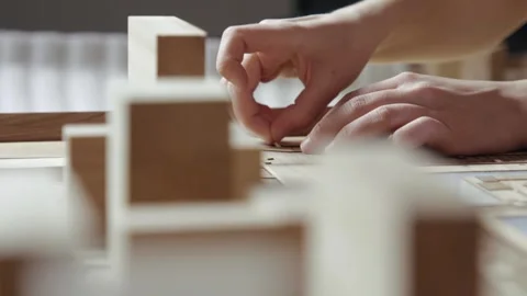 Hands of Professional Man Constructing Architecture Model of Urban Town Building Video stock 285706557