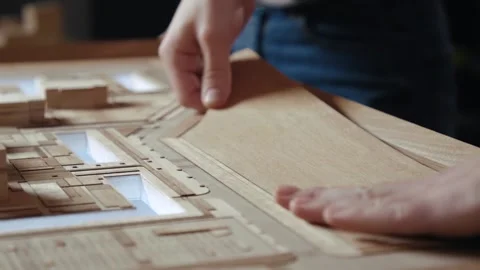 Hands of Professional Man Constructing Architecture Model of Urban Town Building Stock Footage 293401233