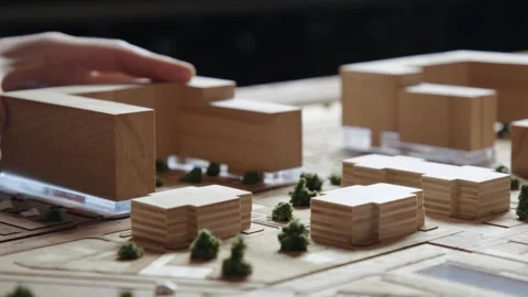Hands of Professional Man Constructing Architecture Model of Urban Town Building Stock Footage 293756834
