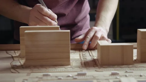 Hands of Professional Man Constructing Architecture Model of Urban Town Building Stock Footage 296518163