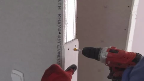 The hands of a professional repairman installing a plasterboard structure Stock Footage 278808894