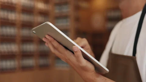 Hands of professional waiter touch screen of tablet computer in cafe closeup Stock Footage 309141404