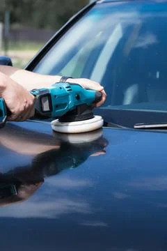 Hands of a professional worker using a cordless electric power buffer machi.. Stock Photos