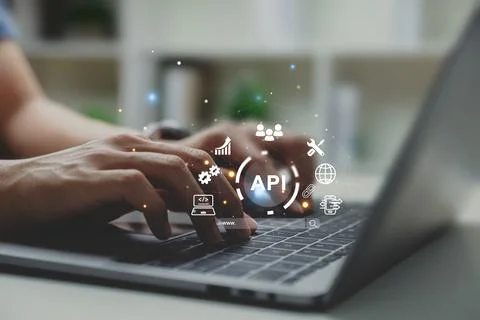 Hands of programmer and laptop with API or Application Program Interface. 库存照片