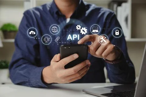 Hands of programmer and smartphone with API or Application Program Interface. Foto stock