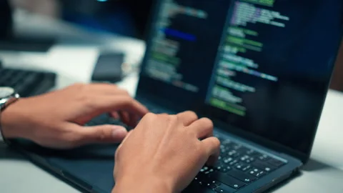 Hands of programmer coding software on laptop screen Stock Footage 313807430
