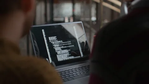 Hands of Programmers Holding Laptop with Codes on Screen Stock Footage 319993520