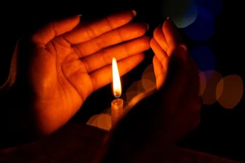 Hands Protecting Candle Stock Photos