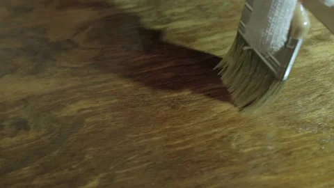 Hands in protective gloves. Man is varnishing an old wooden table Video stock 145322671