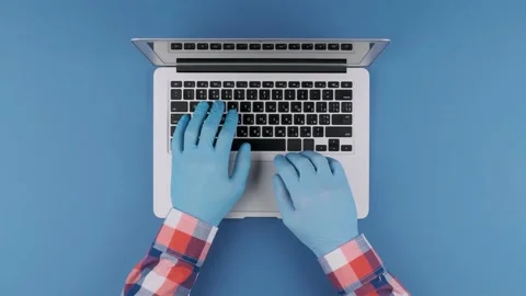 Hands in protective gloves typing on a laptop keyboard. Top view Stock Footage 131672550