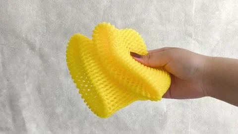 Hands pull foam mesh for fruit packaging. Packaging for transportation, delivery Stock-Footage 332409800
