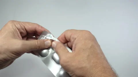 Hands pull the pill out of the blister in 4K Stock Footage 140928726