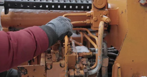 Hands pull rigs crane control at a construction site in winter Stock Footage