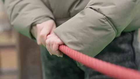 Hands pull rope. Intimate scene capturing hands tense during rope pull. Closeup Stock Footage 345527987