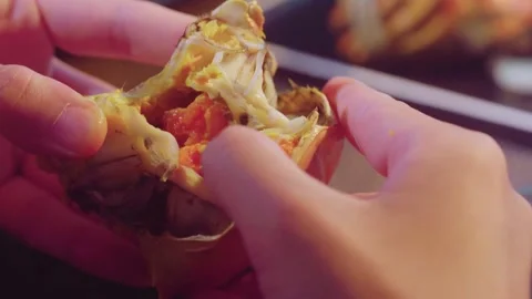 Hands Pulling Apart Cooked Crab Shell to Reveal Meat Stock Footage 339070096