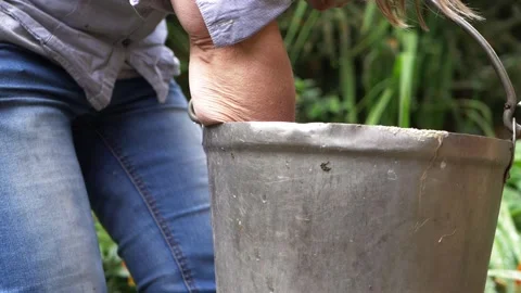 Hands pulling waste out of metal bucket Stock Footage 160924574