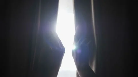 Hands pulling a window curtain for warm morning light. Slow motion.  Young wo Stock Footage