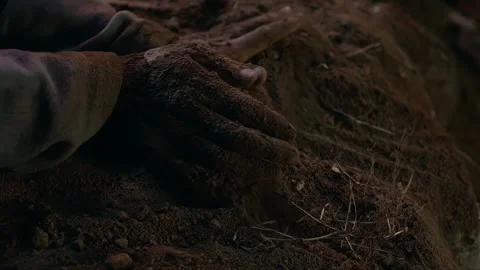 The hands push soil to bury objects Stock Footage 276518679