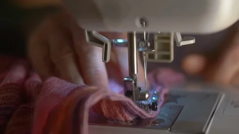 Hands pushing textile through sewing machine in slow motion Stock Footage 70457844