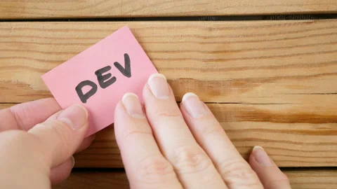 Hands put on board words Dev and Ops. DevOps Concept for software engineering Stock Footage 130798627