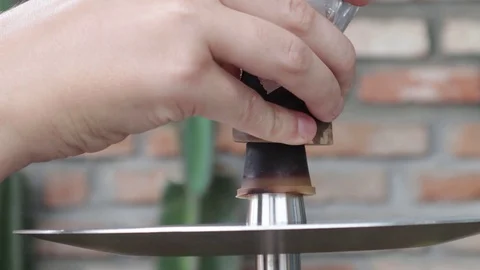 Hands put a bowl for a hookah Stock Footage 119556462